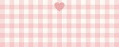 a pink and white checkered table cloth with a heart on it