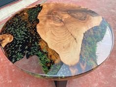 a glass table with an animal's head on it and plants growing out of the top