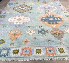 a blue rug with various colorful designs on it