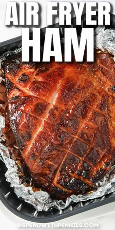 an air fryer ham on tin foil with the words, air fryer ham