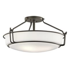 a semi flush ceiling light with frosted glass shades on the bottom and an iron frame