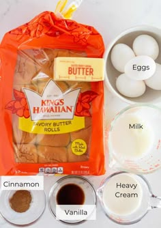 ingredients to make king hawaiian cookies laid out on a white counter top, including eggs, milk, cinnamon, and sugar