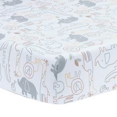 a baby crib sheet with elephants and giraffes printed on the sheets