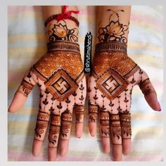 two hands with henna designs on them