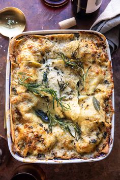 a casserole dish with cheese and herbs