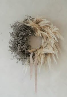 a dried wreath on a white wall