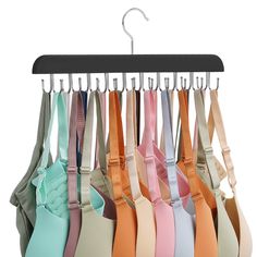 a bunch of bras hanging on a clothes hanger with clips attached to them