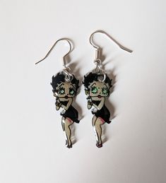 A pair of shrink plastic earrings featuring a full body dangle set of Betty Boop. The earrings are coated in UV Resin and have stainless steel hooks. All of my creations are hand drawn and colored by me so each one is unique and may have slight differences in the pairs. If you would like to request a custom order, send me a message!  I do not accept returns at this time, please message me with any concerns and I will work with you to make it right! Thank you for checking out my art! Shrink Plastic Earrings, Handmade Dangle Earrings, Plastic Earrings, Earrings Handmade Dangle, Shrink Plastic, Etsy Earrings Dangle, Uv Resin, Dainty Necklace, Betty Boop