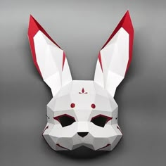 an origami rabbit mask is shown on a gray background, with red and white details