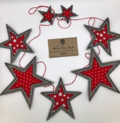 red and white stars are hanging on a string