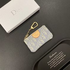 a small keychain sitting on top of a table next to a card case