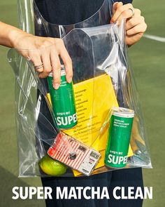 a person holding a bag full of sports items