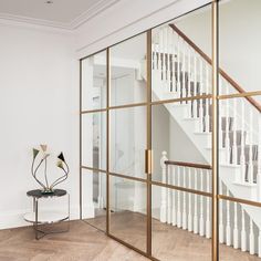 a white room with glass walls and stairs