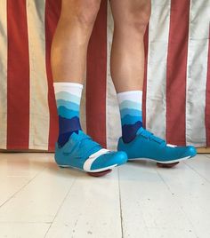 a person wearing blue and white socks standing in front of an american flag