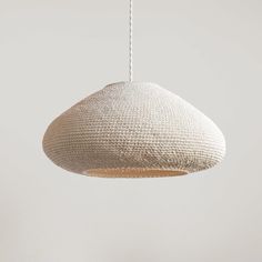 a white light hanging from a ceiling