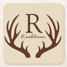 deer antlers with the letter r in brown on a beige background beverage coasters