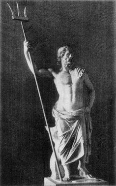 an old black and white photo of a man holding a staff in front of a statue