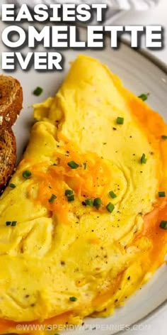 an omelette is served on a plate with toast