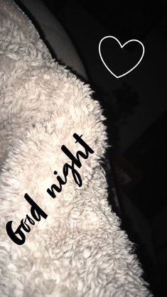 a white teddy bear with black writing on it