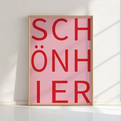 a red poster with the words sch on it in front of a white wall