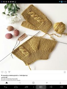 two crocheted pieces of yarn next to each other on a table with knitting needles