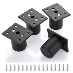 three black metal brackets with screws on them