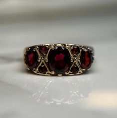 Beautifully crafted vintage red stone ring with a detailed gold setting.  Pre-loved item, some wear on the stones Stamped 9 375 for 9KT Ring Size: 6.25 US Weight: 3.534g **FREE shipping within Canada and USA** If you have any questions or concerns, please do not hesitate to contact us. We will be more than happy to help you and answer any inquiries.  We invite you to check out our shop for more fabulous items! Antique Garnet Promise Ring, Ornate Gold Ruby Ring, Vintage Garnet Birthstone Rings, Vintage Garnet Promise Ring, Antique Red Ruby Ring In 14k Gold, Ornate Gold Ring With Ruby, Ornate Gold Rings With Ruby, Vintage Gold Ruby Birthstone Ring, Gold Ruby Ring Vintage Birthstone