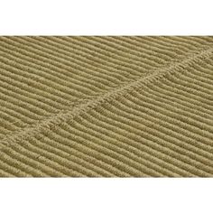 a close up view of the textured fabric on a beige rug with vertical stripes