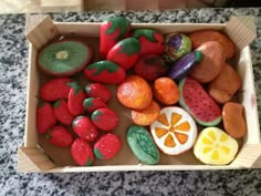 a box filled with fake fruits and vegetables