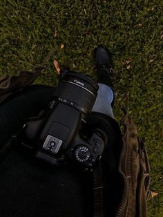 the camera is sitting on someone's back with their feet up in the grass