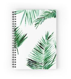 a spiral notebook with green palm leaves on it