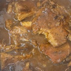 meat and gravy are being cooked in a pan