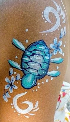 a woman's leg with a turtle painted on it