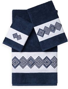 two towels with blue and white designs on the front, one is folded in half