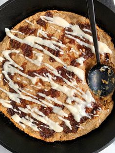 a skillet with some food in it and a spoon on the plate next to it