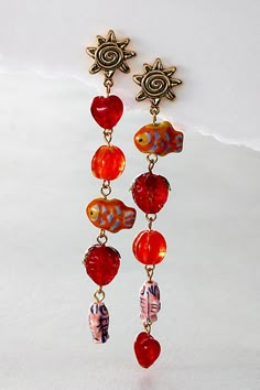 Just as unique as they are undeniably beautiful, these stunning dangle earrings feature tiered, vintage-style glass beads with sun-inspired pendants at top for an added special touch. **Features:** Long dangly design, post-back closure, mix-matched beading for added interest **Why We ❤ It:** *The* perfect pair to add a head-turning touch to absolutely any style. | Euro Summer Dangles by Free People in Red Artsy Earrings, Funky Glasses, Everyday Wear Jewelry, Euro Summer, Bold Jewelry, Fall Earrings, Mismatched Earrings, Summer Earring