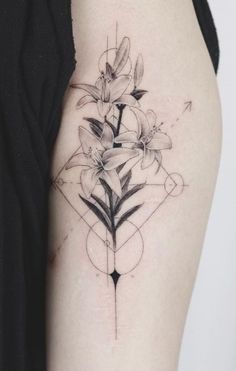 a black and white photo of a flower tattoo on the left upper half of the arm