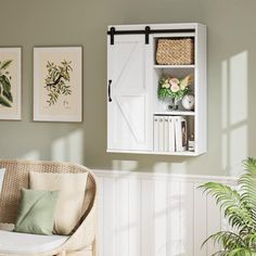 a living room filled with furniture and pictures hanging on the wall above it's door