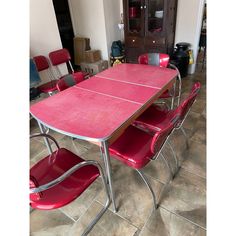 a red table and chairs in a room