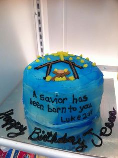 a blue birthday cake sitting on top of a refrigerator