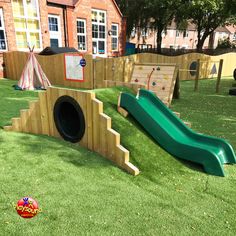 an outdoor play area with slide and tunnel