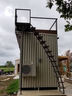 a small metal structure with stairs leading up to the top and bottom part of it