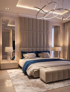 a large bed sitting in the middle of a bedroom under a chandelier above it