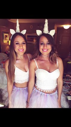 two women dressed up in unicorn costumes posing for the camera with their hands on their hipss