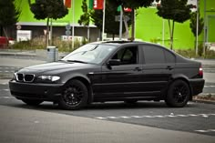 a black car is parked on the street