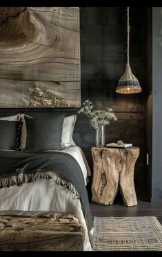 a bed room with a neatly made bed and a wooden table next to the bed