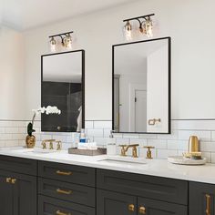 a bathroom with two sinks, mirrors and lights on the wall above them is decorated in black and gold