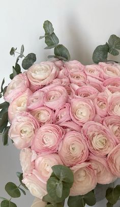 a large bouquet of pink roses and greenery