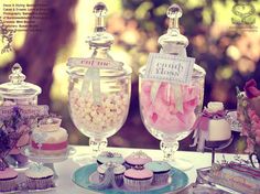 a table topped with lots of cupcakes and candy