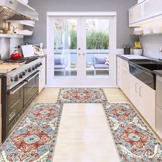 a kitchen with an area rug on the floor